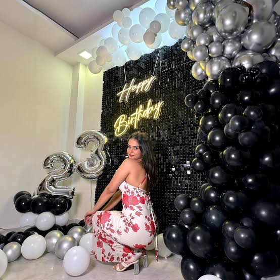 Happy Birthday neon sign with black and silver balloon wall decoration